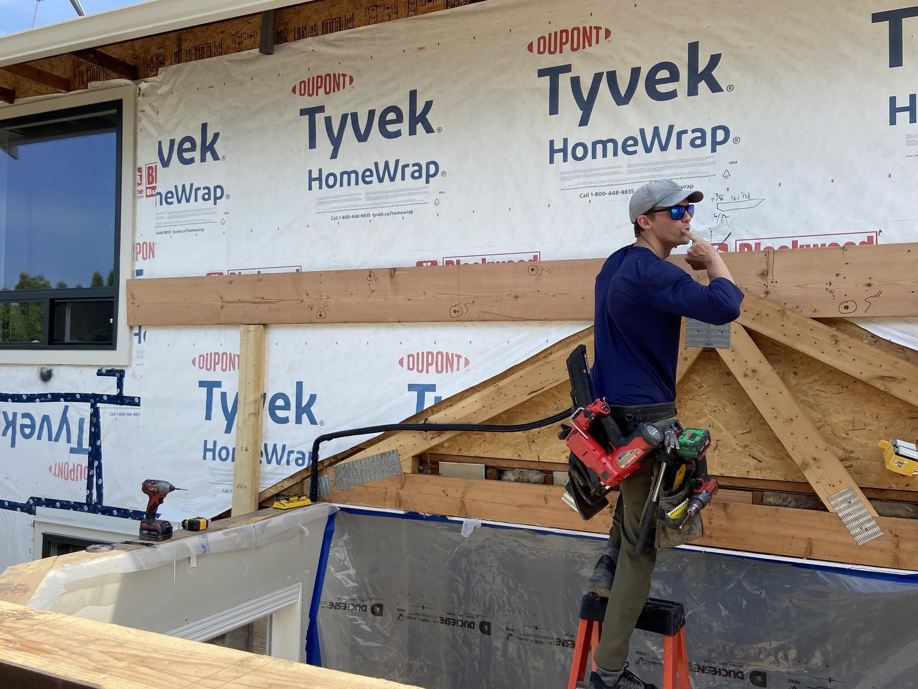 A Connect Contracting carpenter working from a ladder on a framing job in Abbotsford BC