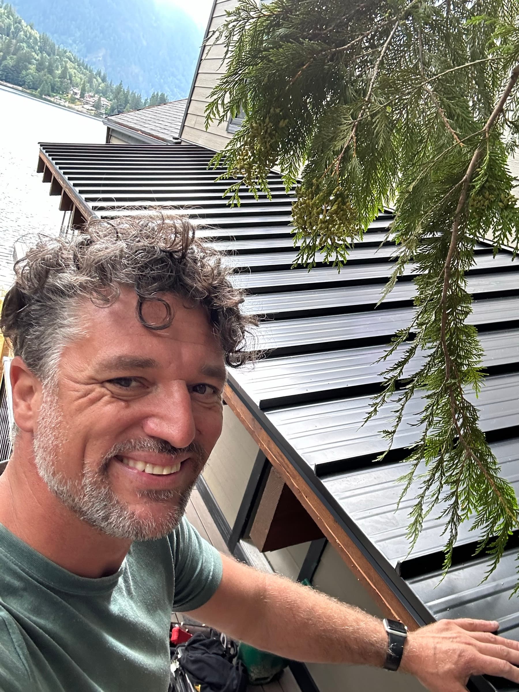Jonathan Van Dyke on a recent job site, standing in front of a slat-screened building with the Fraser Valley behind him